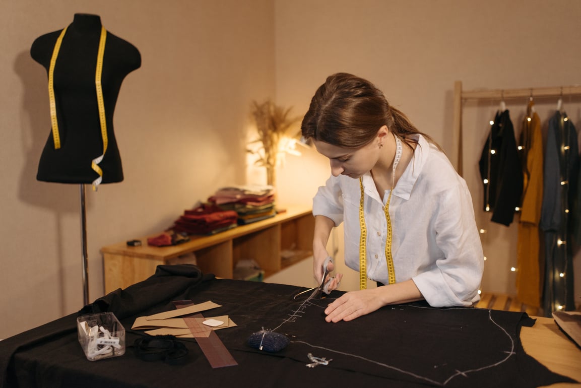 A Woman Cutting a Fabric